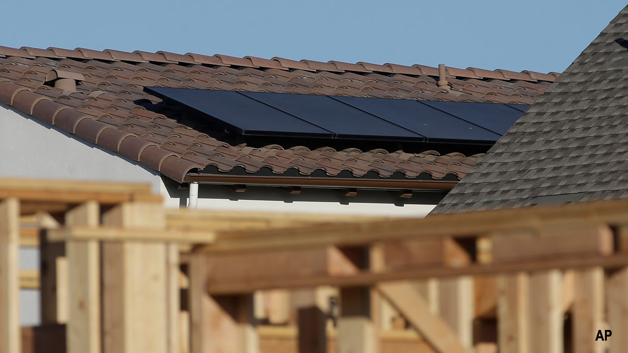 Solar panels are seen on the rooftop on a home in a new housing project in Sacramento, California